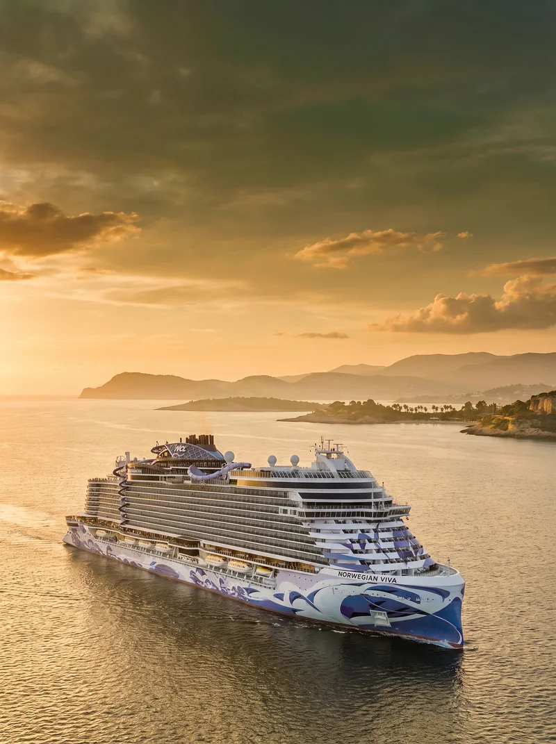 The Norwegian Viva at sea under a golden sunset